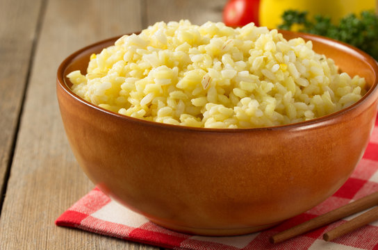 bowl full of rice on wood