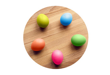 colorful easter eggs on a circular wooden board