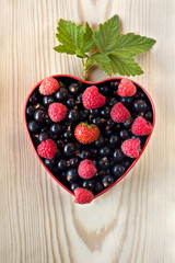 raspberries, black currants in a bowl