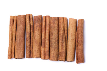 Top view row of aromatic cinnamon sticks.