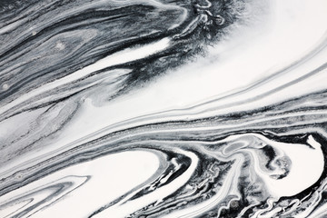 Mix of a white and black paint, closeup.