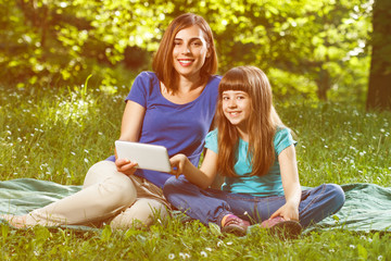 Mother and daughter using digital tablet