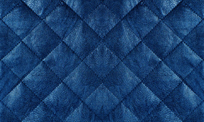 Blue quilted leather fabric close up, abstract background