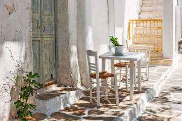 Table and chairs outside a typical house in Mykonos