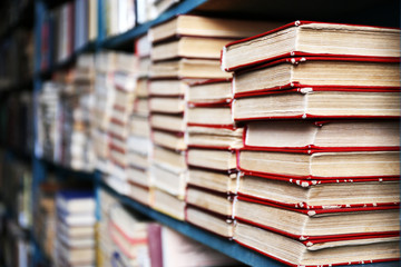 Many books on bookshelf in library, closeup