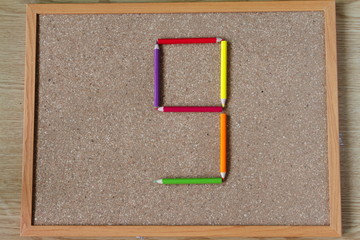 Board and numbered and colored pencils