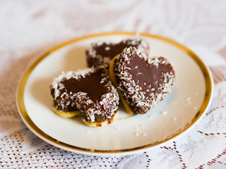 Fototapeta na wymiar Chocolate coconut cookies in shape of hearts