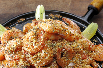 A frying pan with cooked prawns