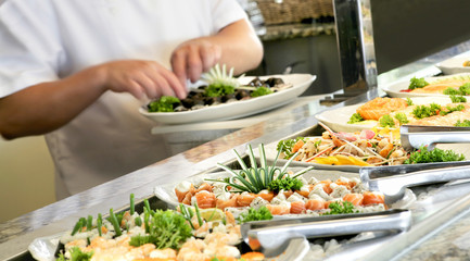 A shallow depth of field image looking along a sushi buffet bar