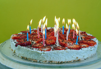 Birthday candles on the cake with strawberries.