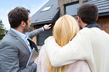 Real estate agent shows details to customers