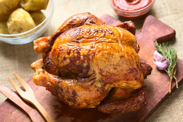 Roast chicken on wooden board