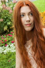 Fototapeta premium Long Hair Woman At the Garden looking Afar