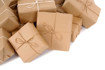 Untidy pile or heap of several lots brown paper wrapped parcel package or gift boxes isolated on white background photo