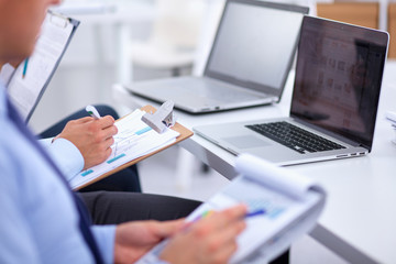 Business people sitting and writting at business meeting, in