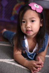 Female toddler laying on ground
