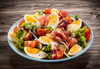 Boiled eggs with smoked ham and vegetables