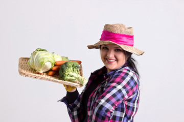 Smiling Garden Woman Holds a Tray of Vegetables