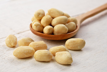 peanut in the spoon on wooden