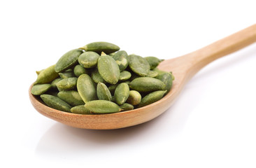 pumpkin seeds in the spoon on white background