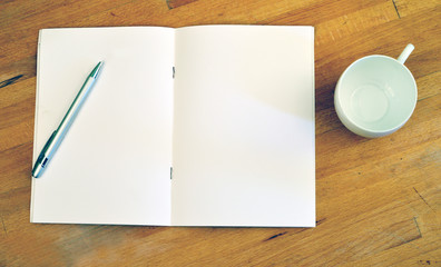 Empty pages of a notebook with a cup, flat lay