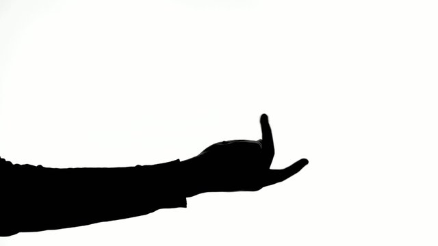 Magician shows the trick with magic ball, silhouette