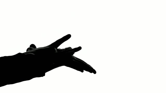 Magician shows the trick with two magic balls, silhouette