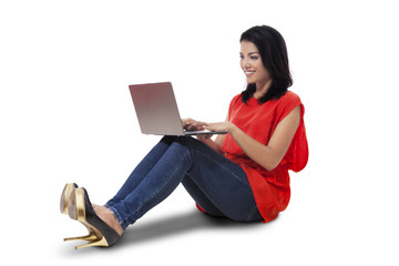 Young lady using laptop on the floor