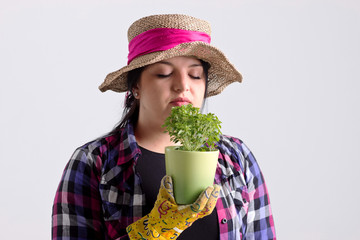 Woman Gardener in Leghorn is Smelling a Herb