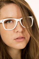 Young female model portrait wearing white glasses hair in face
