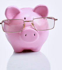 Piggy bank with glasses in isolated white