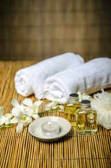 Massage concept, massage oil and white towels