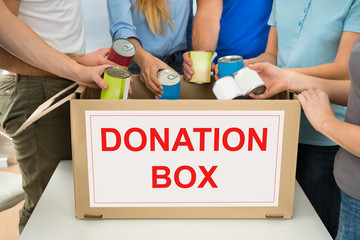 People With Donation Box Holding Cans