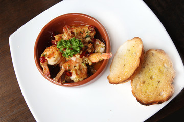Spanish tapas dish, sizzling prawns with chili and garlic
