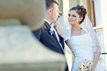 bride and groom near old build