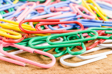 group of colorful paper clip on wooden board