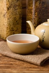 Obraz na płótnie Canvas Oriental tea cup on jute cloth