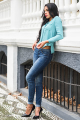 Hispanic young woman wearing casual clothes in urban background