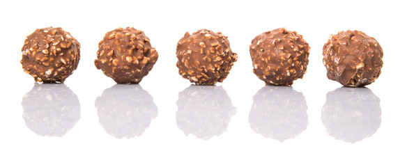 Chocolate balls with nuts over white background