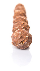 Chocolate balls with nuts over white background