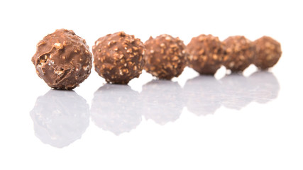 Chocolate balls with nuts over white background