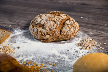  Group of different types of bread on old wooden table