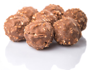 Chocolate balls with nuts over white background