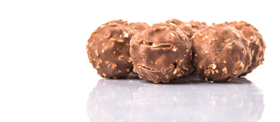Chocolate balls with nuts over white background