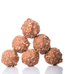Chocolate balls with nuts over white background