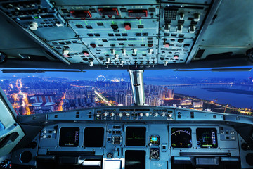 plane cockpit and city of night - obrazy, fototapety, plakaty