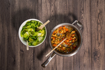 Sliced fresh vegetables with meat in pan