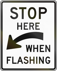 United States traffic sign: Stop here when flashing