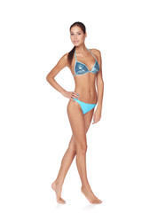 Naklejka premium Slim tanned woman in blue bikini