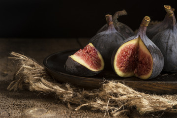 Fresh figs in moody natural lighting set with vintage retro styl